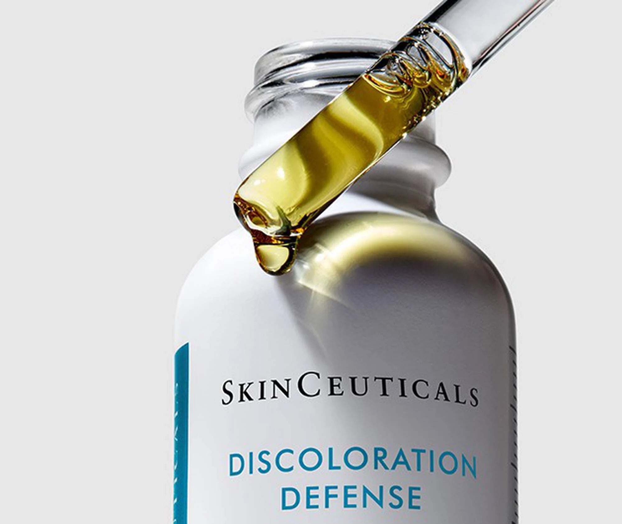 SkinCeuticals Discoloration Defense serum bottle with dropper on a light gray background
