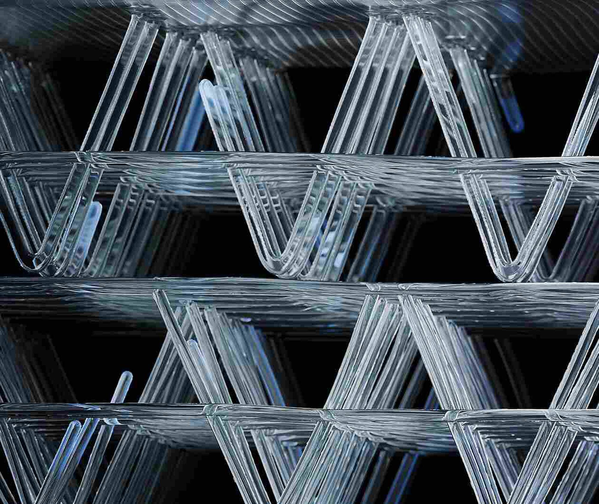 Stack of clear plastic trays with a black background