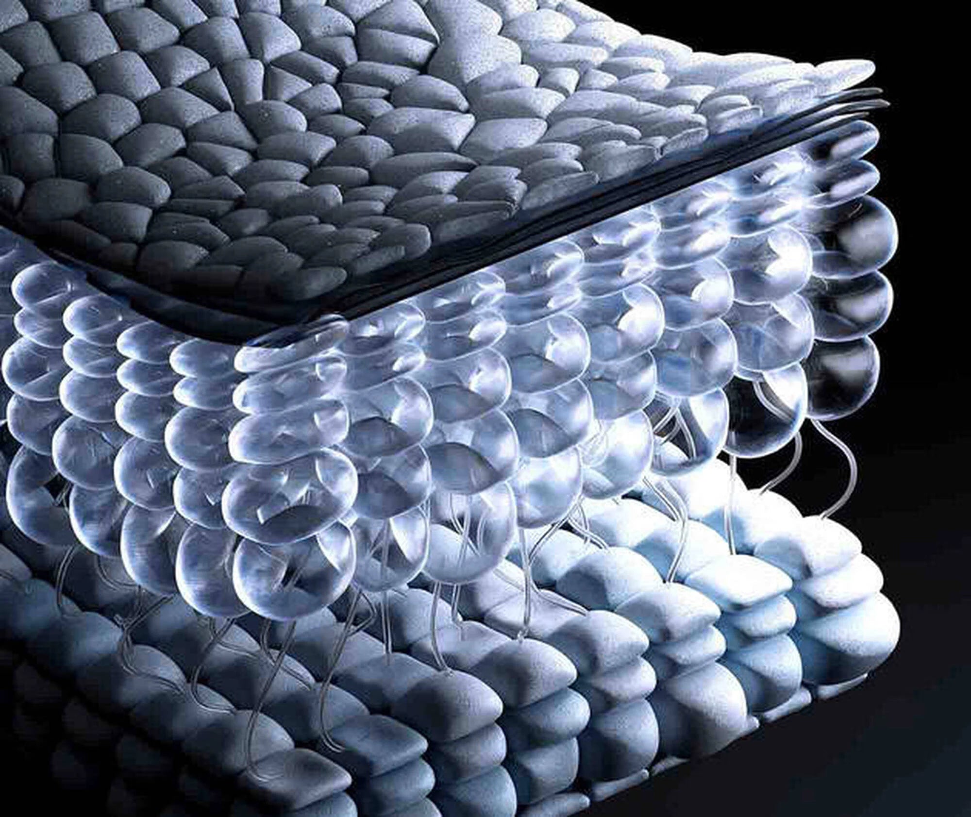Close-up of a mattress with a textured surface and bubble wrap-like material.