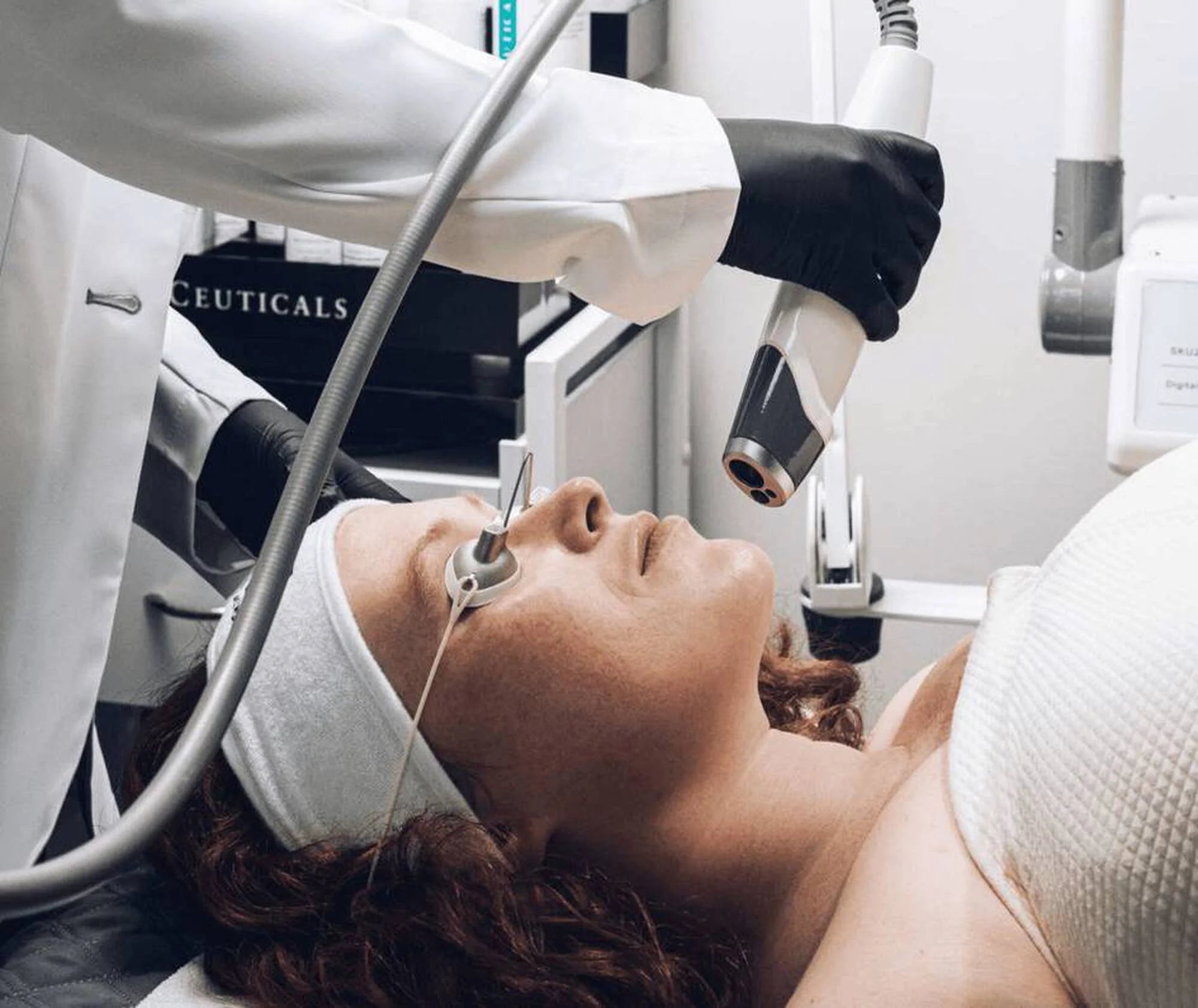 Person receiving a facial treatment with medical equipment labeled 'Ceuticals'.