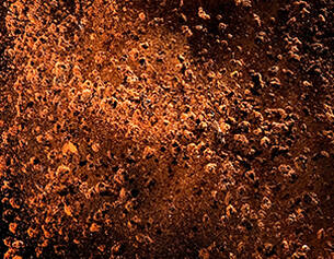 Close-up of rusted metal surface with brown and orange colors