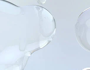 Close-up of a clear glass object on a light gray background