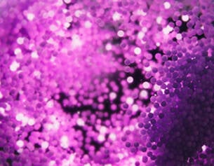 Purple glittery background with a heart shape