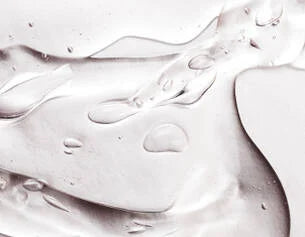 Close-up of white cream texture on a light gray background