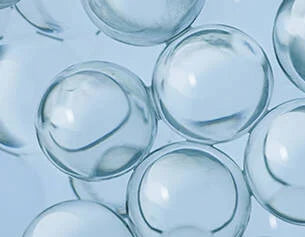 Clear glass marbles on a light blue background