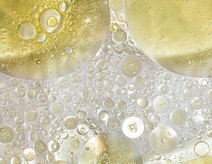 Close-up of oil and water bubbles with a golden hue
