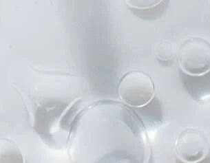 Close-up of clear bubbles on a white background