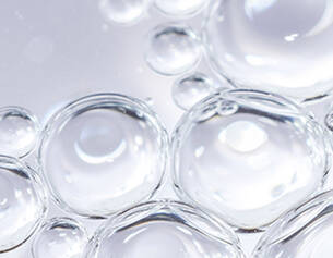 Close-up of clear bubbles on a light gray background