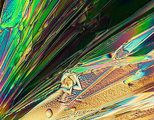 Microscopic view of a crystal structure with colorful fringes