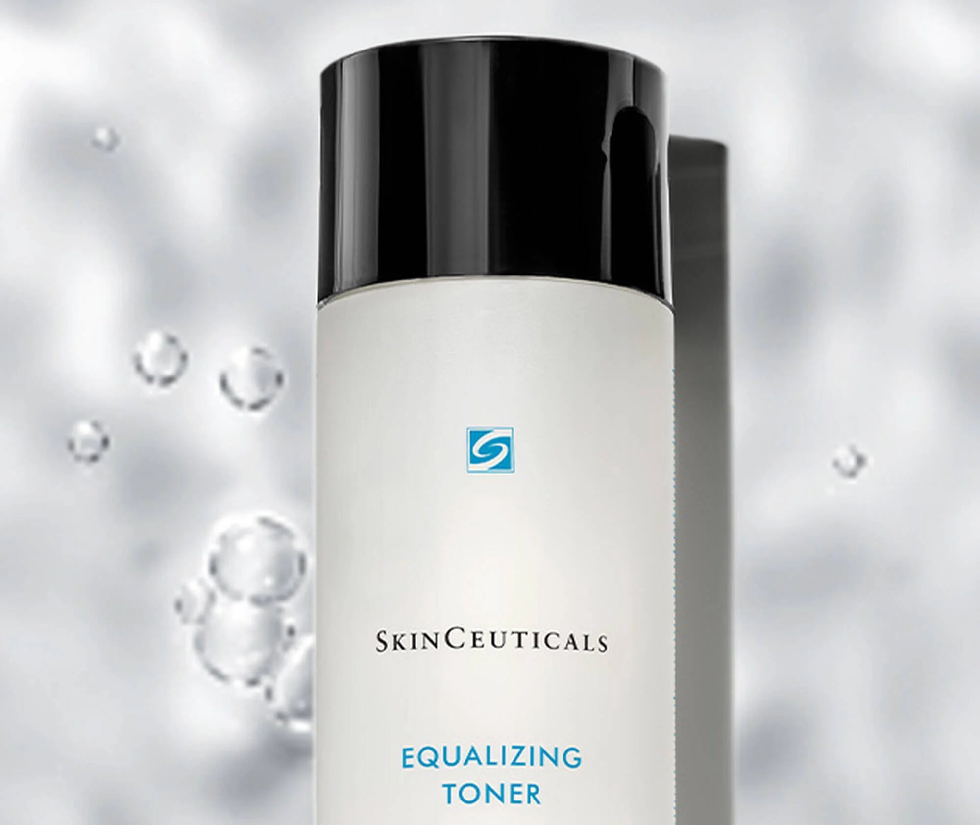 SkinCeuticals Equalizing Toner bottle with a black cap on a blurred background