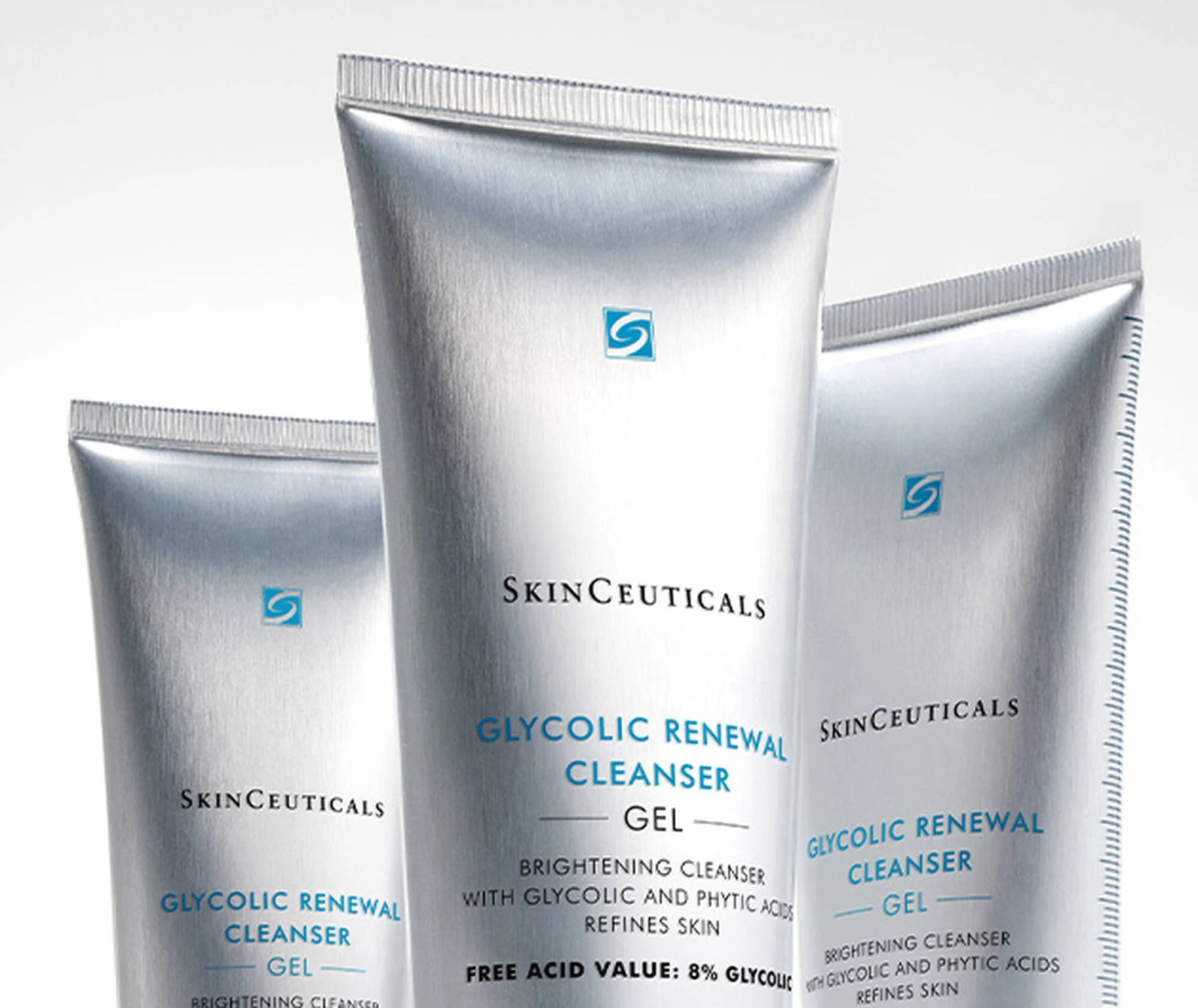 Three tubes of SkinCeuticals Glycolic Renewal Cleanser Gel on a light gray background