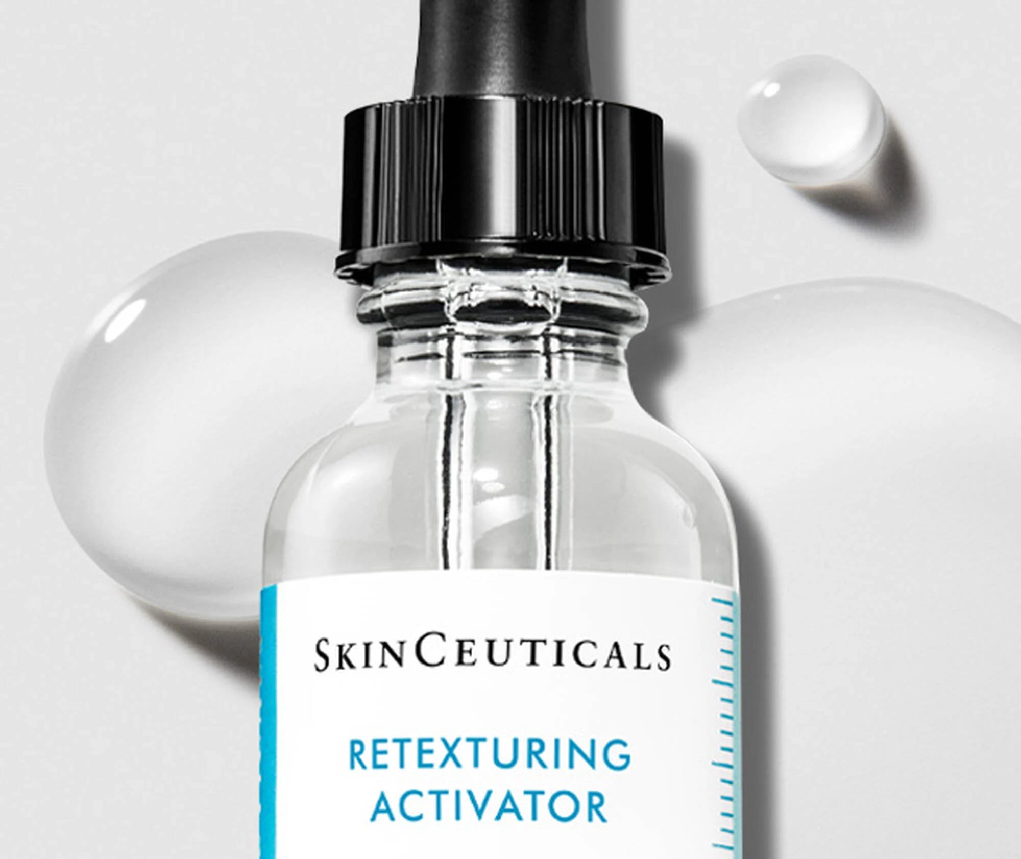 SkinCeuticals Retexturing Activator bottle with dropper on a light gray background