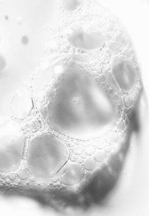 Close-up of water droplets on a surface with a blurred background