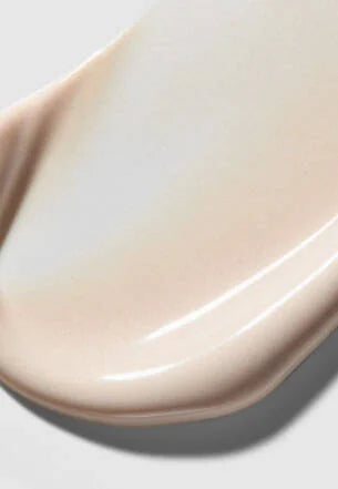 Close-up of a beige cosmetic product on a light gray background