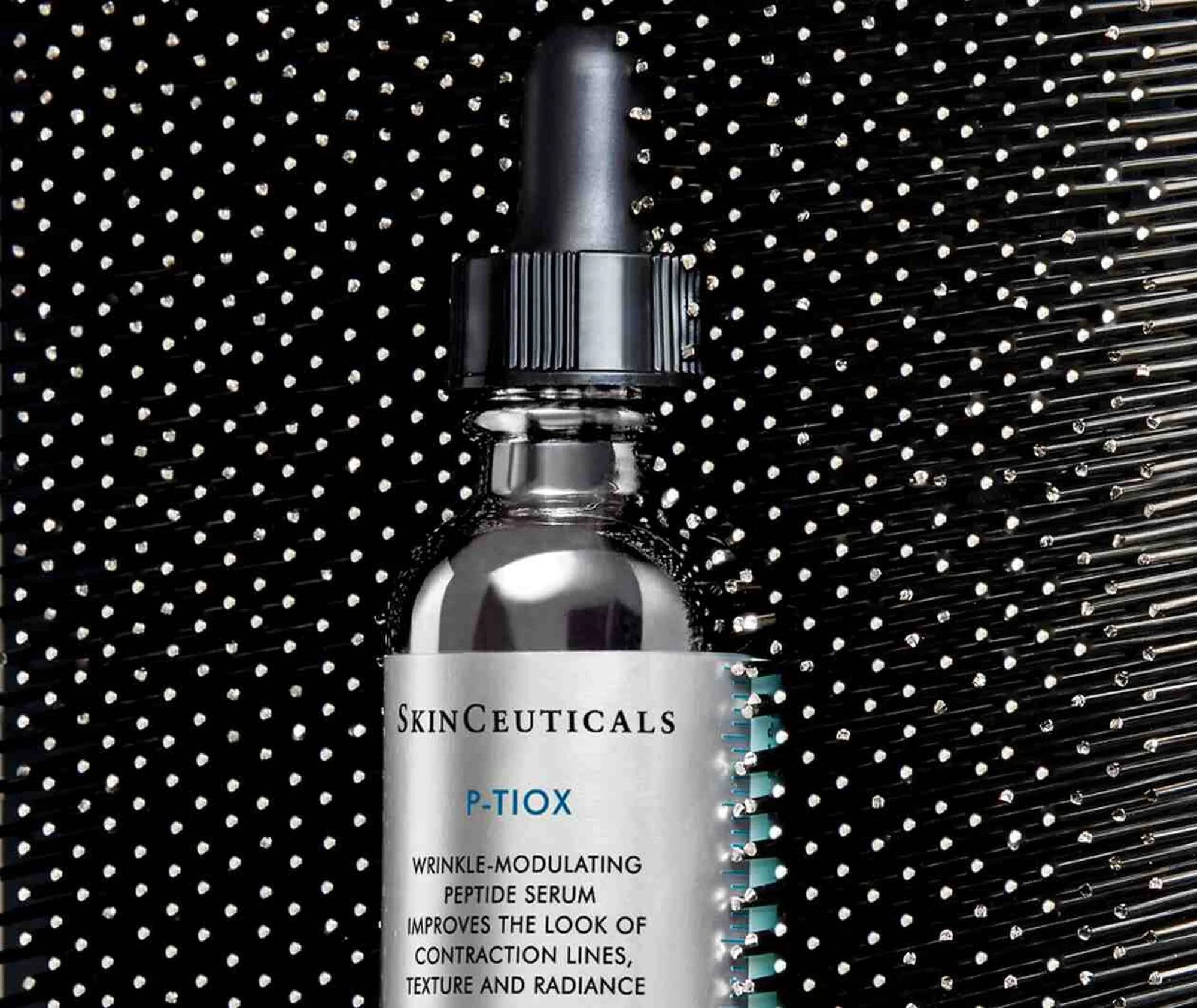 SkinCeuticals P-TiOX serum bottle with black background
