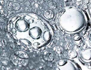 Close-up of water droplets on a metallic surface