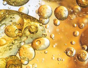 Close-up of oil and water bubbles on a gold background