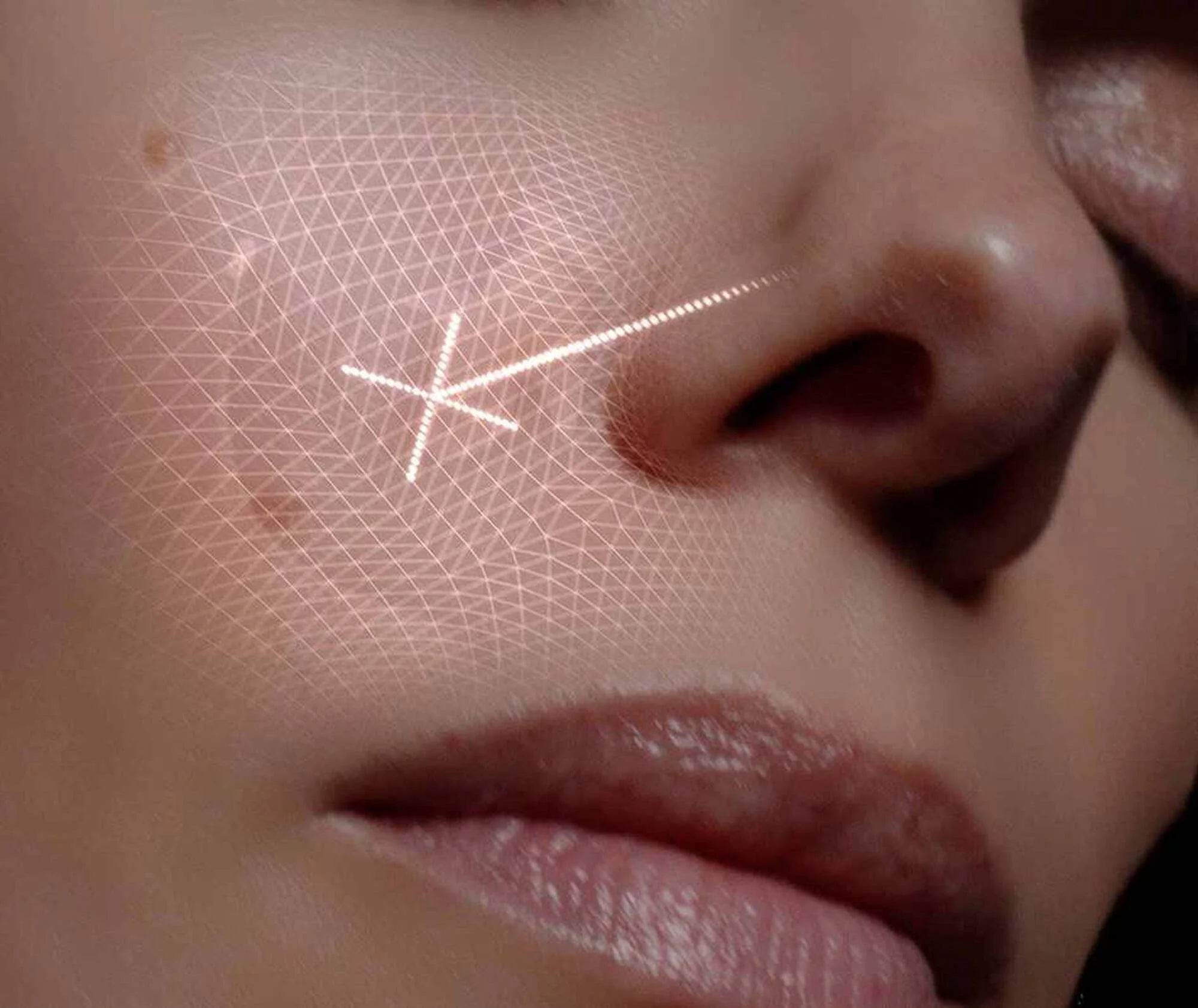 Close-up of a person's face with a geometric star tattoo on their cheek.