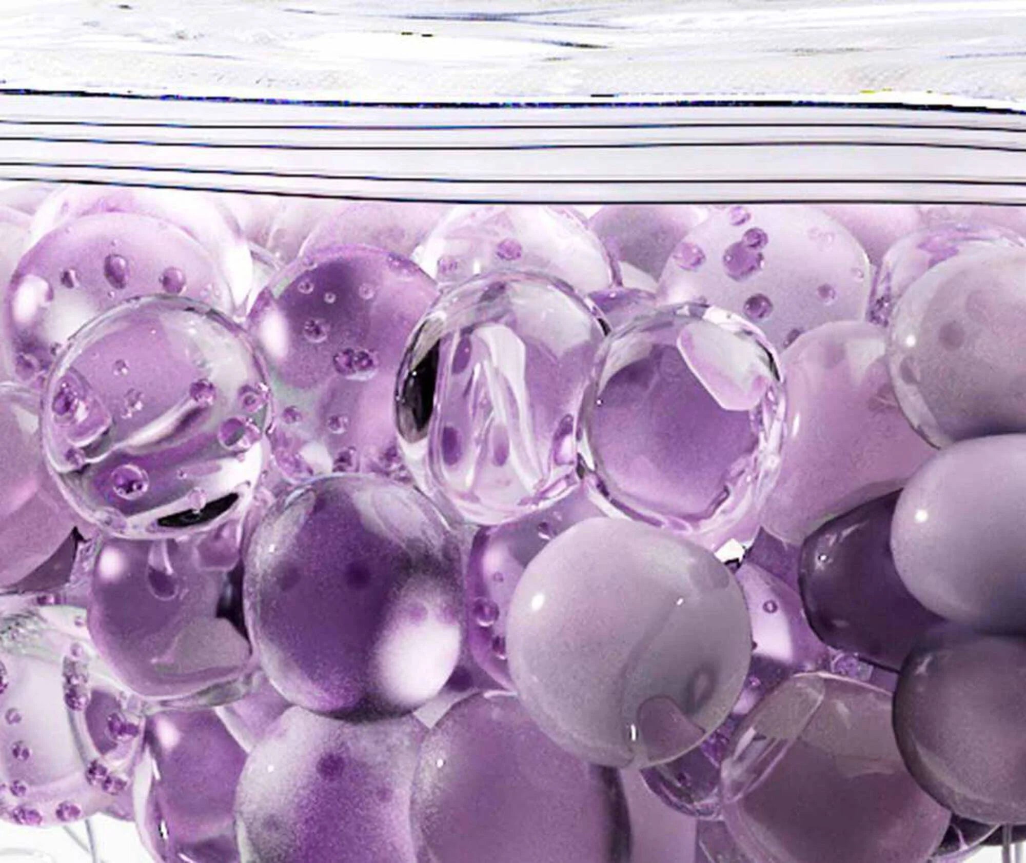 Close-up of purple and clear marbles with a white background