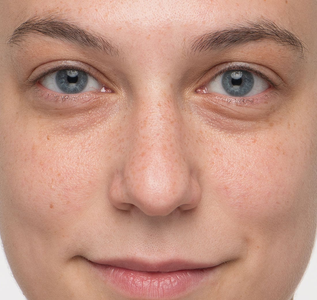 Close-up of a person's face with blue eyes and fair skin.
