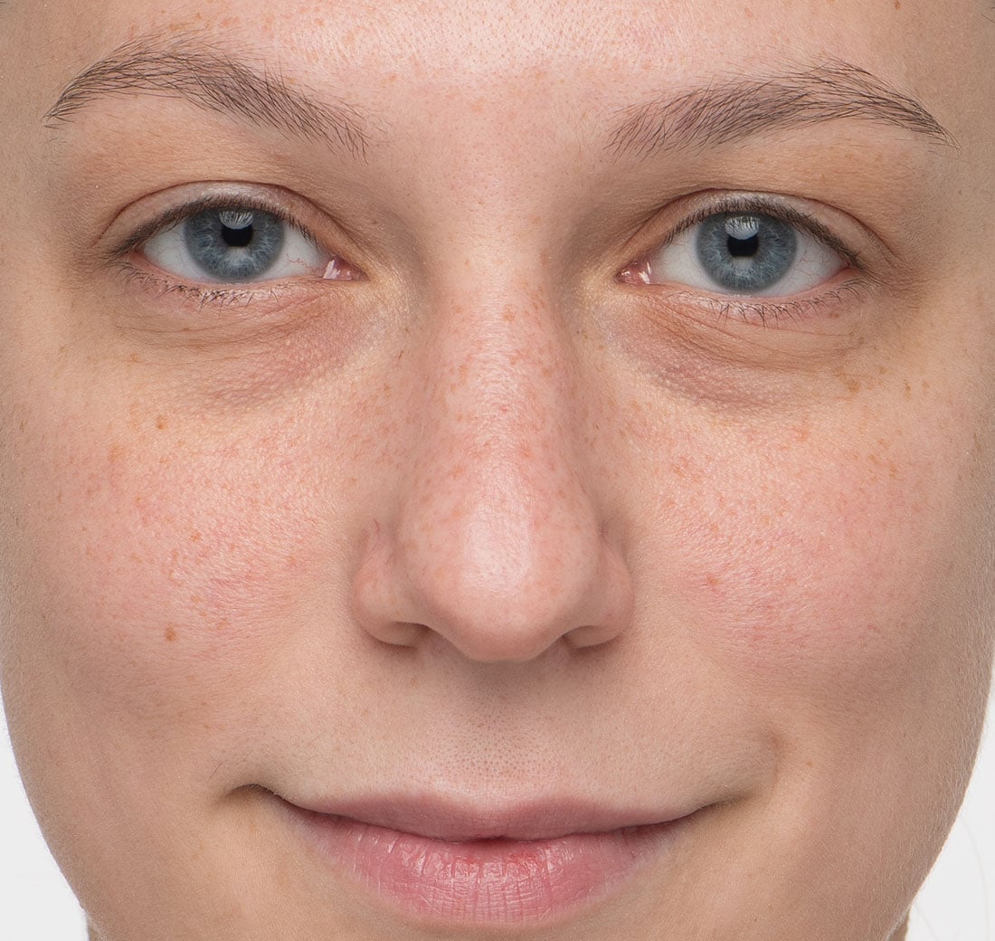 Close-up of a person's face with blue eyes and fair skin.