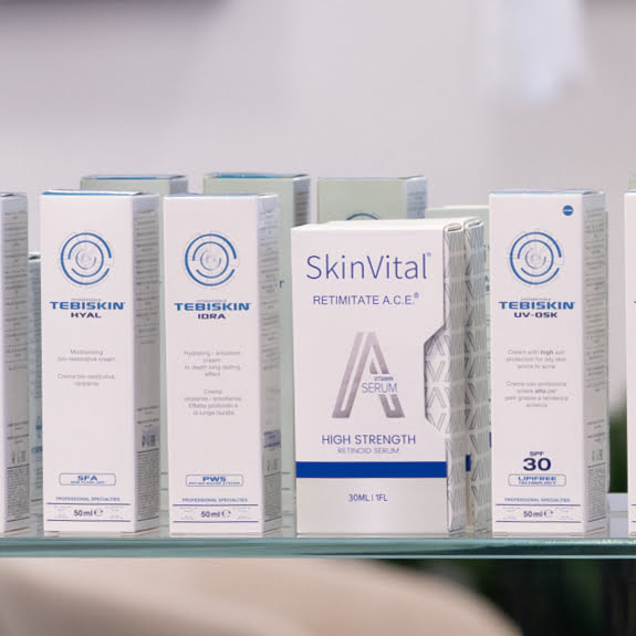 Skinmed products packaging on a glass shelf with a blurred background