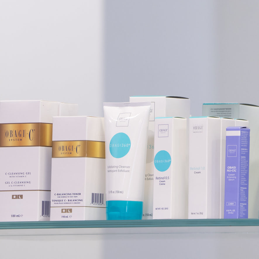 Row of Obagi skincare products on a shelf with a neutral background