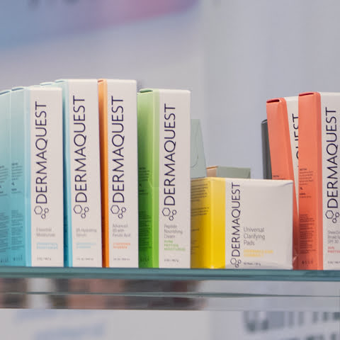 Dermaquest skincare products on a shelf with a blurred background