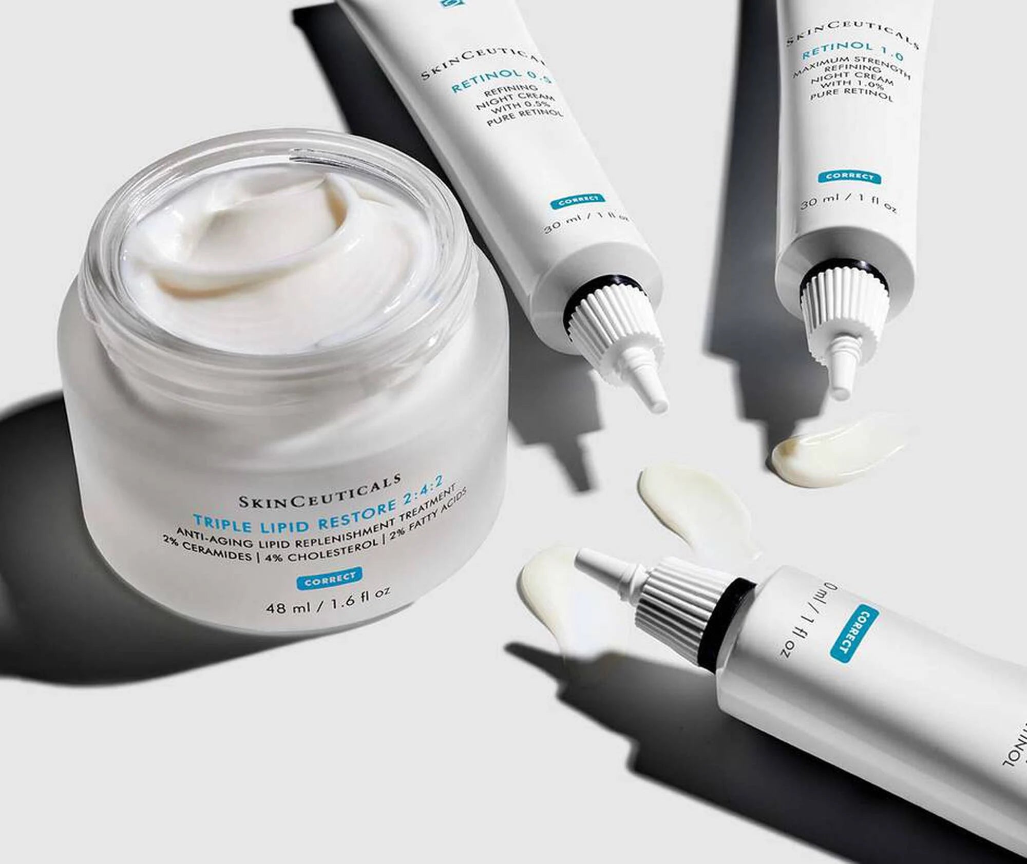 Skincare products including a jar and tubes on a light background