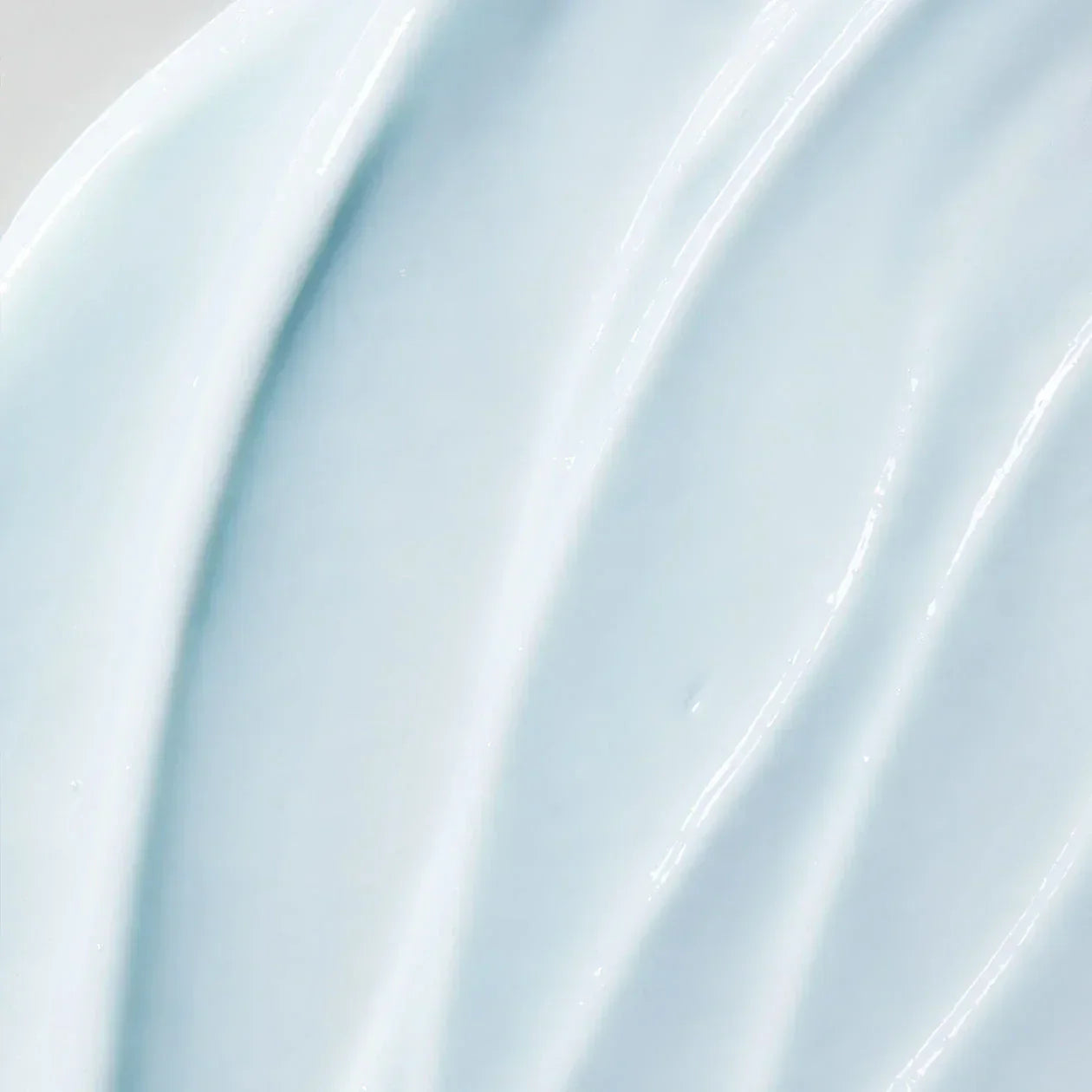 Close-up of a light blue cream with a glossy finish