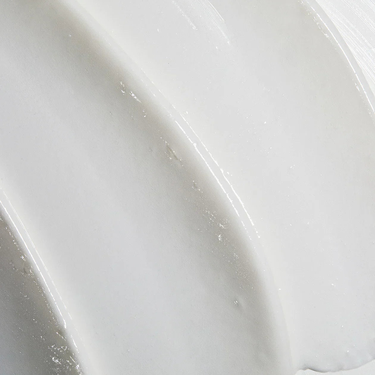 Close-up of a white cream texture with a glossy finish
