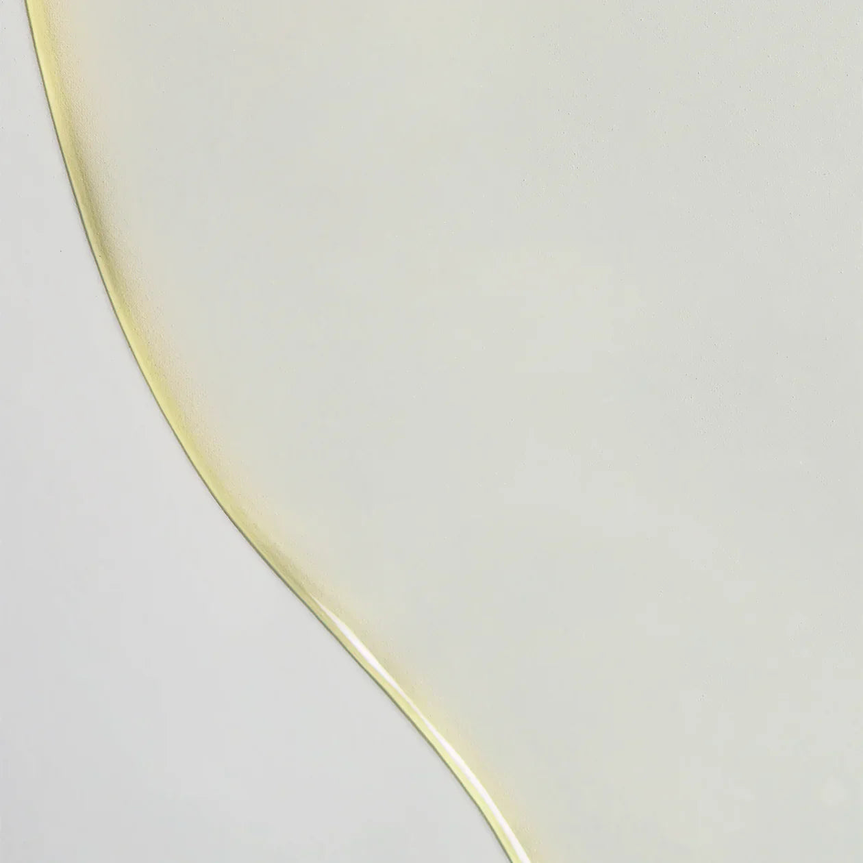 Glass plate with a yellowish tint on a light gray background
