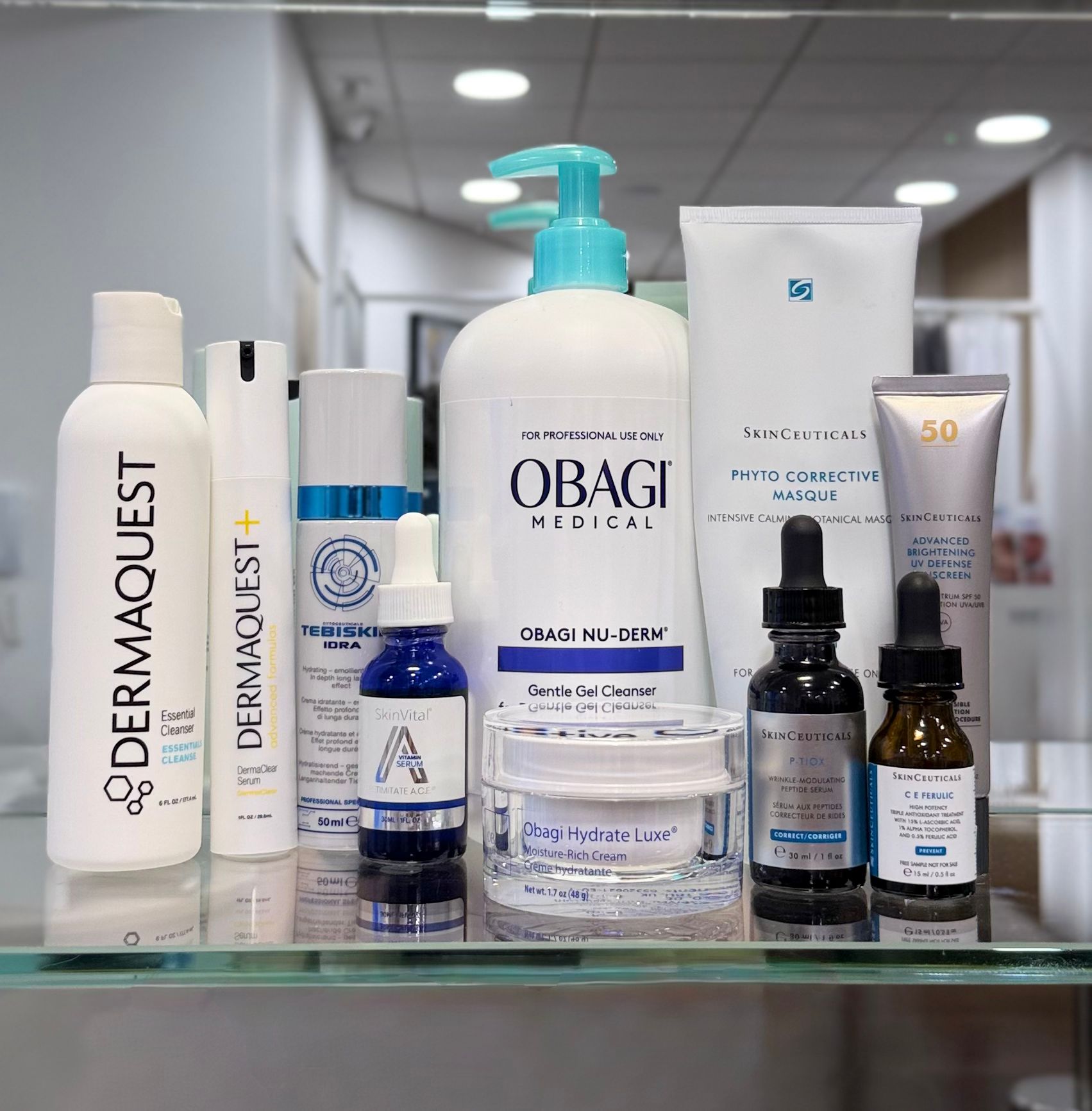 Collection of skincare products on a glass surface with a blurred indoor background