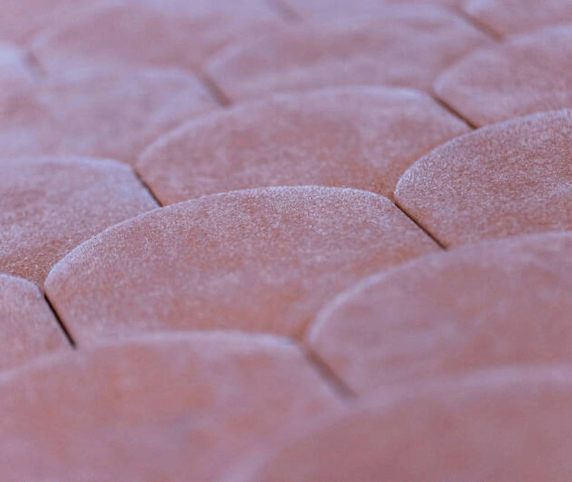 Close-up of pink textured material with a geometric pattern