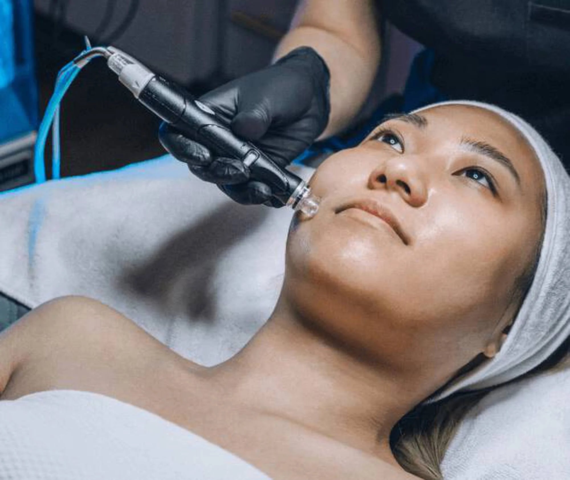Person receiving a facial treatment with a device on their face.